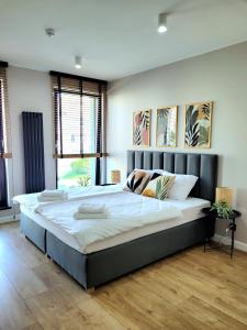 a large bedroom with a large bed in a room at Apartamenty K17 Stare Miasto in Malbork