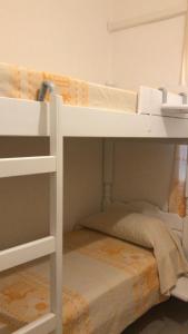 a white bunk bed with a small bed underneath it at APPARTAMENTO LIDO 1 in Alghero +15 photos