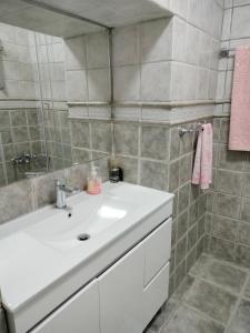 a bathroom with a white sink and a mirror at Quinta de Canelas in Torre de Moncorvo +21 photos