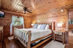 a bedroom with a bed in a log cabin at Pvt Pool at The Grotto in Sevierville +15 photos
