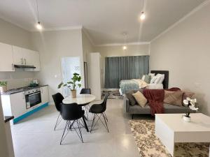 a living room with a couch and a table at Sunningdale White House Accomodations in Cape Town