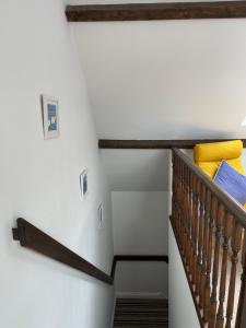 a staircase in a house with yellow pillows at Wynards Farm Sunrise room in Dorchester