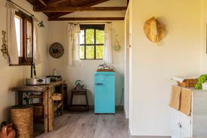 a kitchen with a blue refrigerator and a table at Le Bumbarelle in Tavoleto
