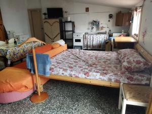 a bedroom with a large bed and a kitchen at Vacanze Serene in Montecilfone