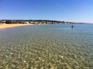 a person standing in the water at the beach at B&B Lu Cantoru in Marina di Pescoluse