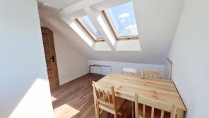 a dining room with a table and some skylights at Wysoka Fala in Jastrzębia Góra