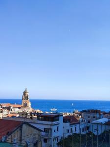 a view of a city with the ocean in the background at #goldenhour in Amalfi