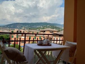 a table with a tea set on top of a balcony at Casa Morgana in Chiavari