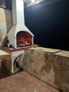 a pizza oven sitting on top of a stone wall at Вила Нелче in Pepelina
