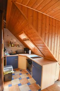 Il comprend une cuisine avec des murs et un plafond en bois. dans l'établissement Harzglück, à Thale 17 autres photos