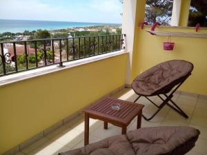 a balcony with a chair and a table at B&B Lu Cantoru in Marina di Pescoluse