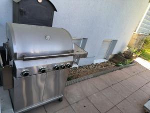a stainless steel barbecue grill sitting outside of a building at Ferienwohnung in Sinzheim bei Baden Baden für 1- 6 Personen in Sinzheim