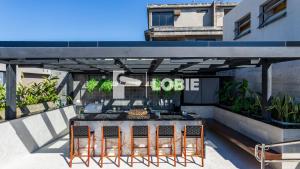 a table and chairs under a kiosk on a building at Lobie Skylux in Rio de Janeiro