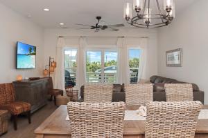 Una sala de estar con un sofá, una mesa y sillas. en Biggies Beach House by Pristine Properties Vacation Rentals, en Mexico Beach 89 fotos más