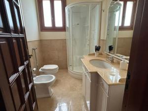 a bathroom with a shower and a toilet and a sink at Casa vacanza da Maria in Petrosino