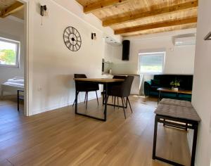 a dining room and living room with a table and chairs at Antiva in Livno