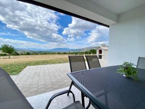 a table and chairs on a patio with a view at Antiva in Livno