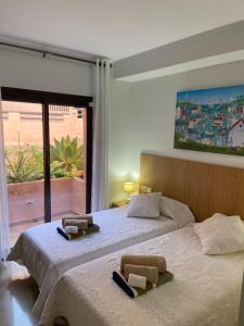 Postel nebo postele na pokoji v ubytování Oasis Coto Real apartments