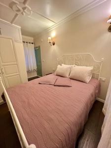 a bedroom with a large bed with a pink blanket at Konak Maksem in Bursa
