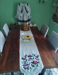 a wooden table with a table cloth with flowers on it at Studio apartman Karmen in Varaždin Breg +36 photos