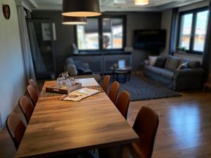 a wooden table and chairs in a living room at Apartmenthaus Hinterer in Bad Goisern