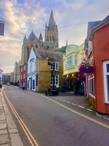 a city street with a cathedral in the background at St Mary's Mews in Truro