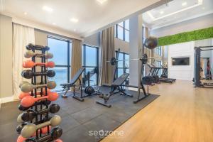 a gym with treadmills and exercise equipment in a room at MHF II - Apts Variados em Prédio com Vista para o Mar em Itapema in Itapema