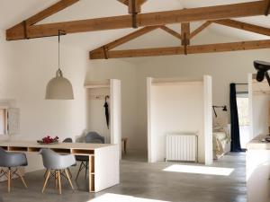 a kitchen and living room with a table and chairs at Loft de diseño en Masía Rural, Cantallops, Girona in Cantallops