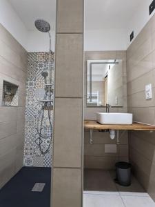 a bathroom with a sink and a shower at Gîte Le Cerbillona- Gavarnie, France in Gavarnie +18 photos