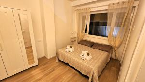 two dogs sitting on a bed in a bedroom at Lux Beach Apartment GOLD in Lido di Ostia