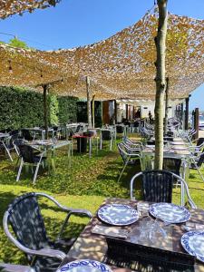 a group of tables and chairs under an umbrella at Hostal Restaurante Parajes in Castropol