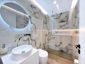 a bathroom with a sink and a mirror at Zace Studios in Ksamil