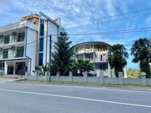 a white building on the side of a street at Hotel Del Mar in Kvariati