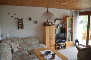 a living room with a couch and a table at Ferienhaus Kroll Thiemen in Vohenstrauß