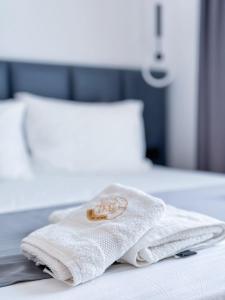 a white towel sitting on top of a bed at Zace Studios in Ksamil