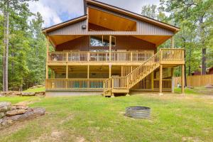 a large wooden house with a large deck at Waterfront Retreat on Greers Ferry Lake with Hot Tub in Heber Springs
