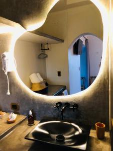 a kitchen with a sink and a circular mirror at WAYTAY in Cafayate +99 photos