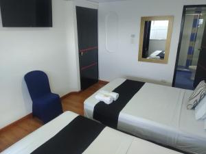 Postel nebo postele na pokoji v ubytování Hotel Bogotá la embajada