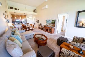 a living room with a couch and a table at Grand Champions Golf Villas 150 in Wailea
