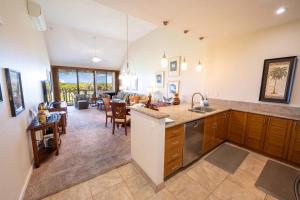 a kitchen and living room with a dining room at Grand Champions Golf Villas 150 in Wailea