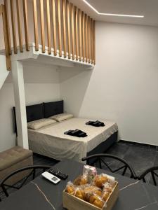 a room with two beds and a table with a box of donuts at Suite Aurora in Crotone