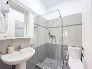 a bathroom with a sink and a toilet and a shower at Zace Studios in Ksamil