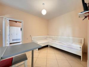a room with two beds and a table in it at Zace Studios in Ksamil