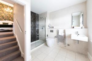 a bathroom with a shower toilet and a sink at Roomours Hotel with Private Car Park in Llandudno +83 photos