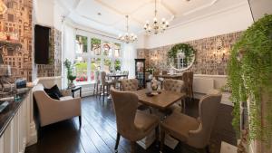 a dining room with a table and chairs at Roomours Hotel with Private Car Park in Llandudno