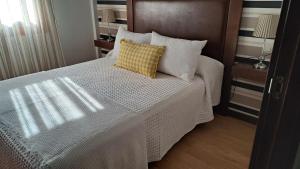Łóżko lub łóżka w pokoju w obiekcie Apartamento AGRELO