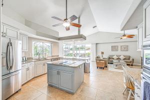 a kitchen and living room with a ceiling fan at Marco Island Home with Screened Pool Less Than 1 Mi to Beach in Marco Island