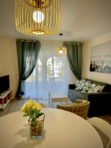 a living room with a table with a vase of flowers at VVVHouse in Manilva
