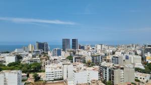 a view of a city with tall buildings at Habitación en casa de Luis con espacios compartidos in Lima