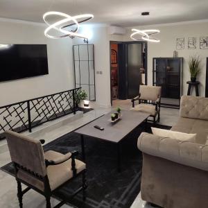 a living room with a couch and a table at Villa Lea Tuzla in Tuzla